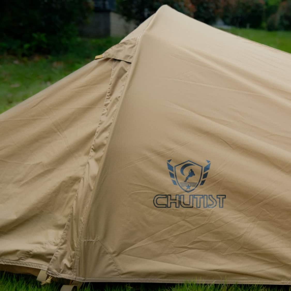 waterproof military tent in heavy rain with reinforced seams and durable canvas material